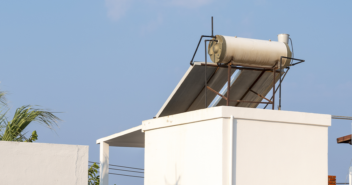 Calentador solar instalado en el techo de una vivienda, reduciendo el uso de gas y aprovechando la energía solar.